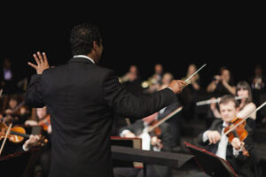 conductor leading symphony orchestra