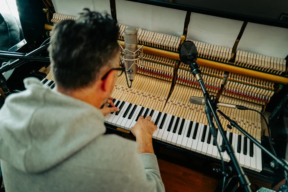John Schroter Playing piano in his hoemstudio