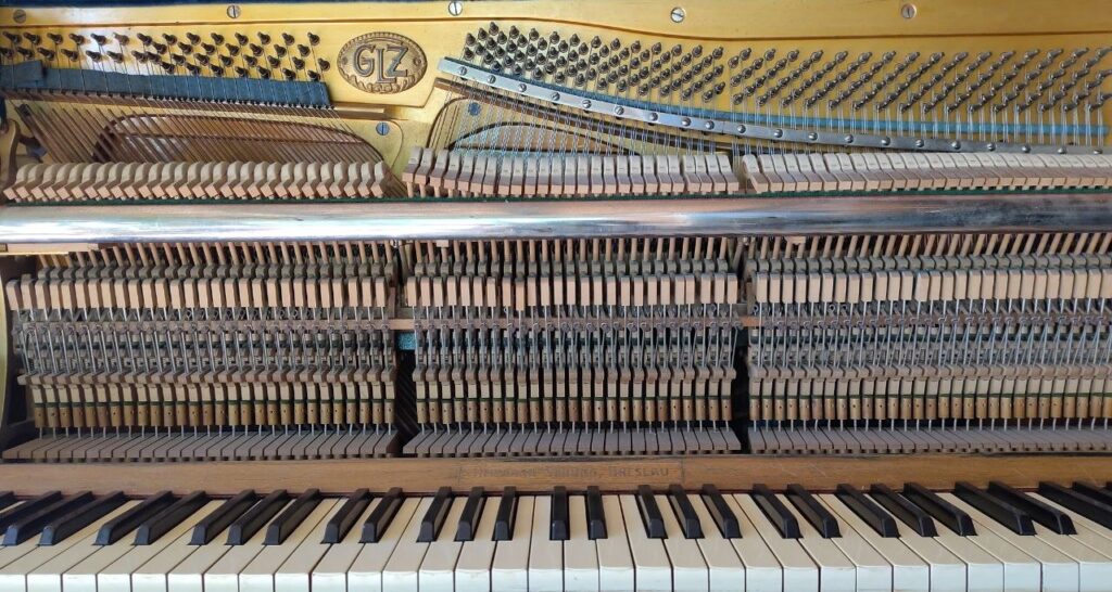 Acoustic upright piano front view of the keyboard claviers and hammer actions