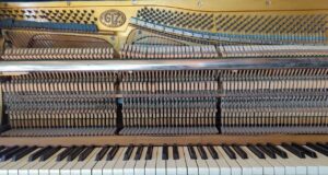 Acoustic upright piano front view of the keyboard claviers and hammer actions