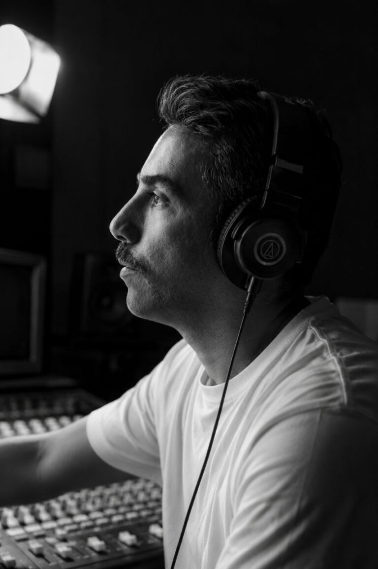Profile portrait of a musician in studio with headphones on his ears. Soshiant Iranian Musician Tunitemusic